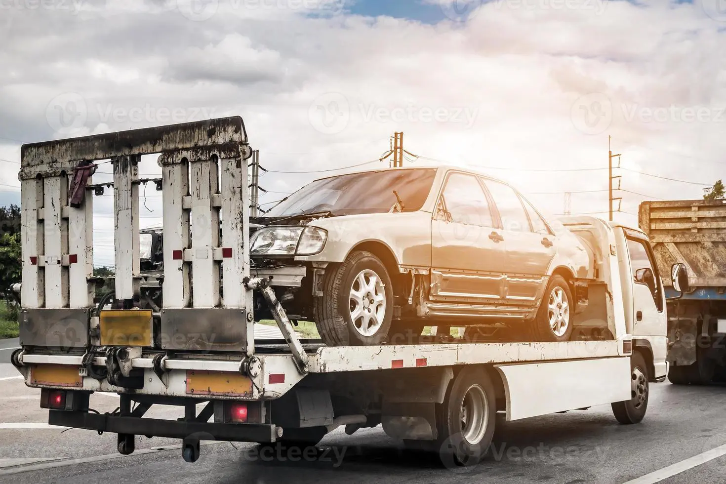 Does Insurance Cover Towing? Here’s What to Know 4 broken-car-on-tow-truck-after-traffic-accident-on-the-road-service-photo
